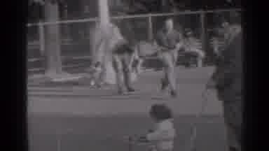 Three men playing leap frog? That's a jumping family affair!