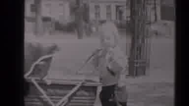 New York (1947): Child Wearing Grey Pants Pushes Baby Carriage In A Bright Sunny