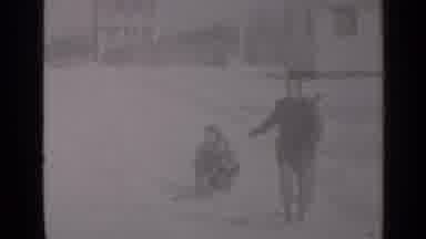 New York (1947): Manwearingg Grey Coat Pulls People On Sled On A Sunny Day