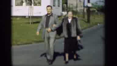 New York (1947): Middle Aged Couple Locking Arms Together Walking In Love Wearing