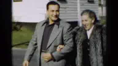 New York (1947): Woman Wearing Grey Fur Coat Walks With Man Wearing Grey Suit On A