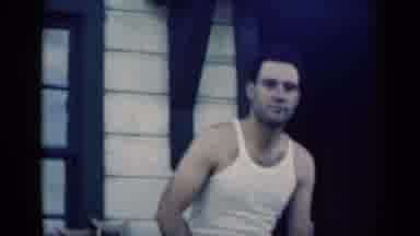 Indiana USA (1948): Family Sitting In Front Of House On Porch Talking With Each