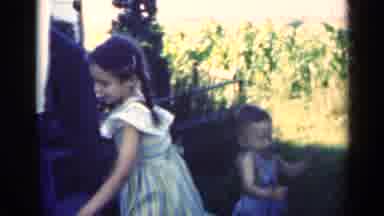 Indiana USA (1948): Toddler Sits On Bicycle Then Older Girl Sits On It And