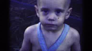 Indiana USA (1948): Little Boy Staring And The Camera And Eventually Smiling