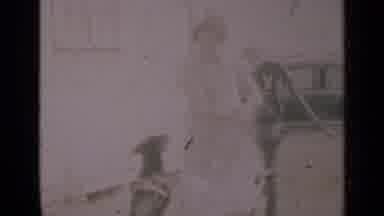 Indiana USA (1948): A Women And Man With A Dog Pumping Water Out Of The Ground