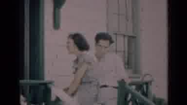 Indiana USA (1948): Young Couple Talks With Older Couple On A Street-Level Front