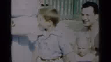 New York-1950: Two Women Tap The Shoulder Of A Young Boy Who Stands Beside A Man