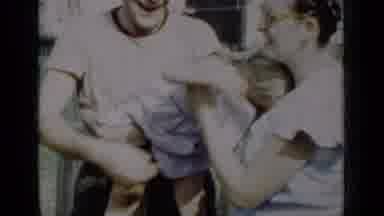 New York (1950): Dad Passing Little Girl To Mom Before Putting Her Down To Play
