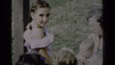 New York (1950): Girl Wearing White Dress Looks At Woman Holding Baby On A Sunny