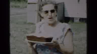 New York (1950): Smiling Elderly Woman With Iced Cake Speaks With A Woman Carrying