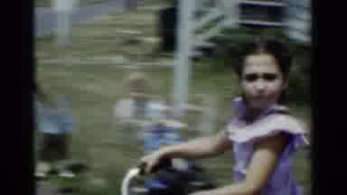 New York (1950): Young Girl Wearing A Dress Riding Her Bike Up And Down The Street