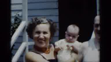 New York (1950): Woman Holds Baby While Man Touches The Baby's Head