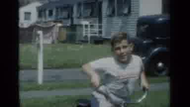 New York (1950): Boy Wearing White Shirt Rides Bicycle On A Bright Sunny Day