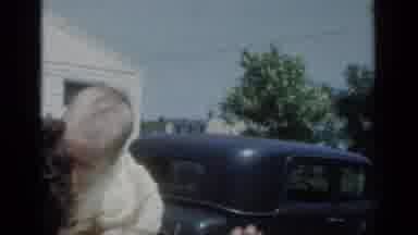 New York (1950): A Lady Playing With A Small Child In Her Arms With House And Car