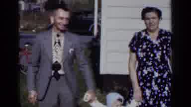 New York (1950): Mom And Dad Holding Baby From Both Hands As She Walks