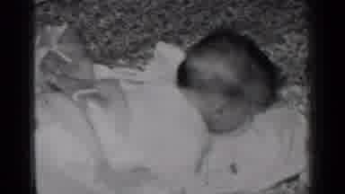 New York (1950): Small Baby Laying On A Bead And Dropping It's Head Into The