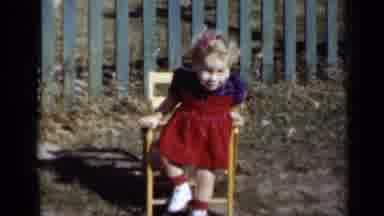New York-1950: Child Sitting In Chair Outside On Sunny Day