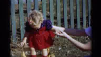 New York (1950): Girl Wearing Red Dress Stands On Yellow Chair On A Bright Sunny