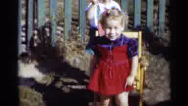 New York (1950): Little Girl In Red Dress Stands In Front Of Chair And Little Boy