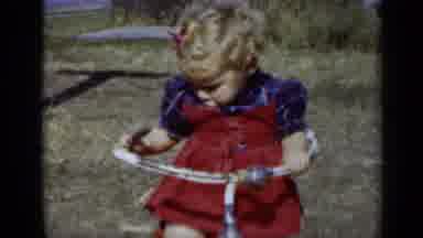 New York (1950): A Little Girl In A Red Dress Plays On Her Tricycle