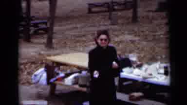 New York (1950): Woman In A Black Coat Walking Around Picnic Tables With Food In