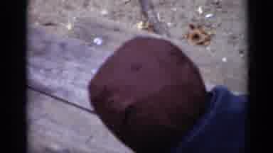 New York (1950): Small Child Walks Towards The Camera Holding And Biting A Piece