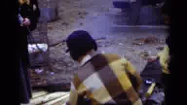 New York (1950): Young Boy In Winter Clothes Roast Marshmallows On Stick Outside
