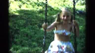 New York (1951): Two Young Girls And A Baby Boy Swinging On A Swing Set With