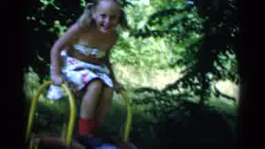 New York (1951): Children Playing On A Slide Near The Forest In Colorful Dresses