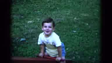 New York (1951): A Young Boy Playing On A Seesaw While Being Lifted Up Slowly