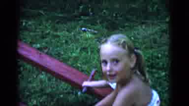 New York (1951): Girl Wearing White Dress Plays On Red Seesaw On A Clear Day