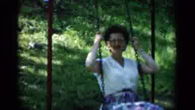New York (1951): Older Lady With Glasses Swinging On An Outdoor Swing Set Wearing