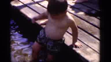New York (1951): Little Boy Standing In Shallow Water Splashing With His Foot As A
