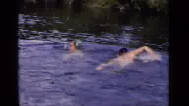 New York (1951): Two People Swim Towards Distant Lake Shore; Smiling Girl Frolics