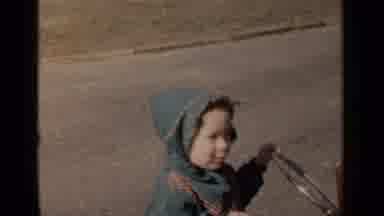 New York (1951): Girl Wearing Green Coat Pushes Brown Baby Stroller On A Bright