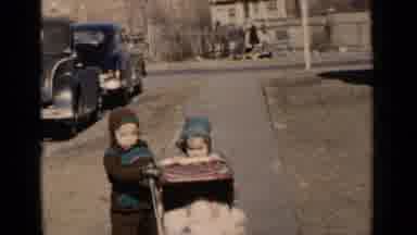 New York (1951): Girl Wearing Green Dress Pushes Brown Baby Carriage On A Sunny