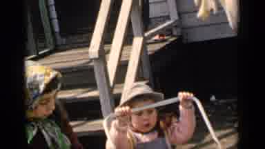 New York (1951): A Toddler Tries To Push A Buggy An Older Girl Tries To Help While
