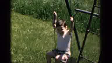 New York (1951): Little Boy Playing Outside On A Swingset On A Beautiful Sunny Day