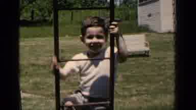 New York (1951): Boy Climbs Ladder As He Smiles At The Camera While He Climbs
