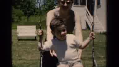 New York (1951): Woman Pushing Boy On A Swing In The Backyard Of A Home