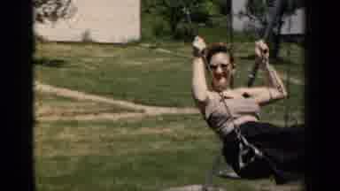 New York (1951): Father And Mother Enjoying With Their Son On The Swing In The