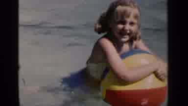 New York (1951): A Child Playing With A Ball In A Pool While A Woman Swims