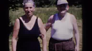 New York (1951): An Old Lady In Black Dress And An Old Man With A Cap Walking With