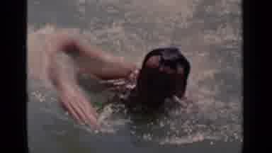 New York (1951): A Man Swimming In Water Towards Another Man With A Boy In Red And