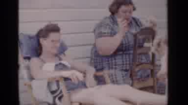 New York (1951): People Sitting On Chairs Outside Watching The Kids Play In A