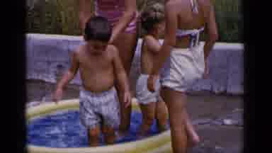 New York (1951): Boy Wearing White Shorts Steps Out Of Yellow Kiddie Pool On A