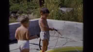 New York (1951): Small Boy Uses Garden Hose To Fill Kiddie Pool As Another Child