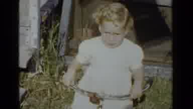New York (1951): Child On Tricycle On A Very Windy Day In A White Dress