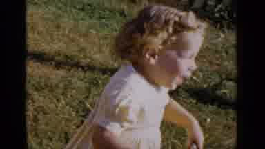 New York (1951): Kid Playing On Grass With A Toy