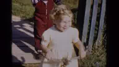 New York (1951): Girl Wearing Yellow Dress Rides Red Tricycle On A Bright Sunny
